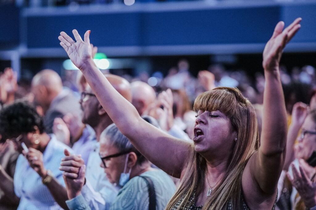 A passionate gathering of people in a church worship service, expressing their faith.